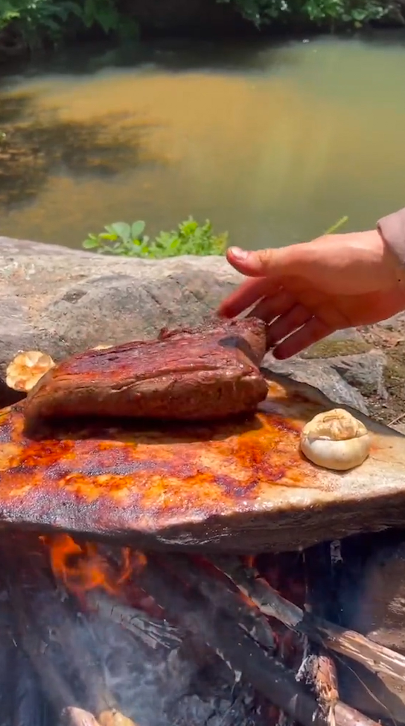 camping cooking on a stone