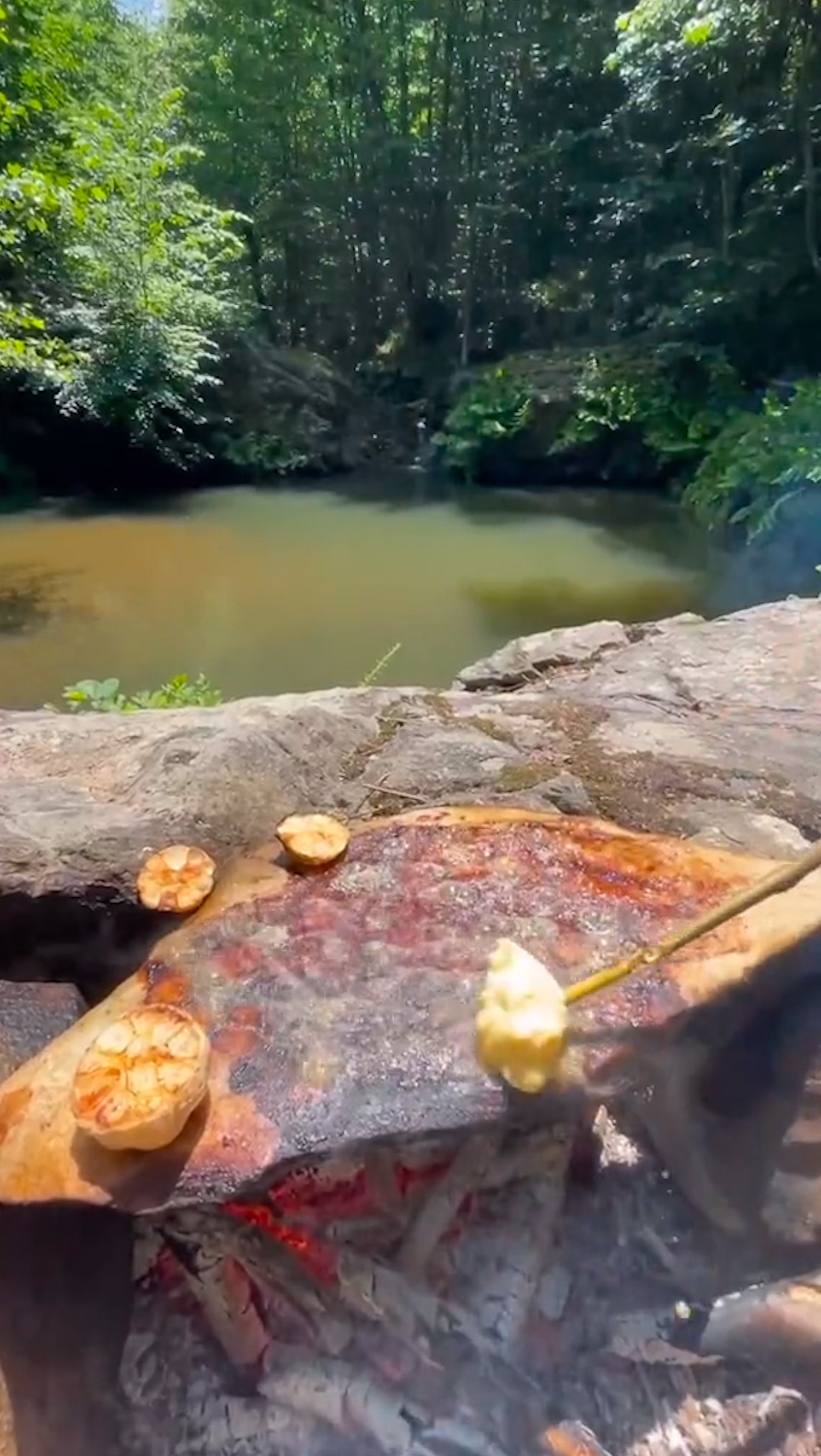 camping cooking on a stone