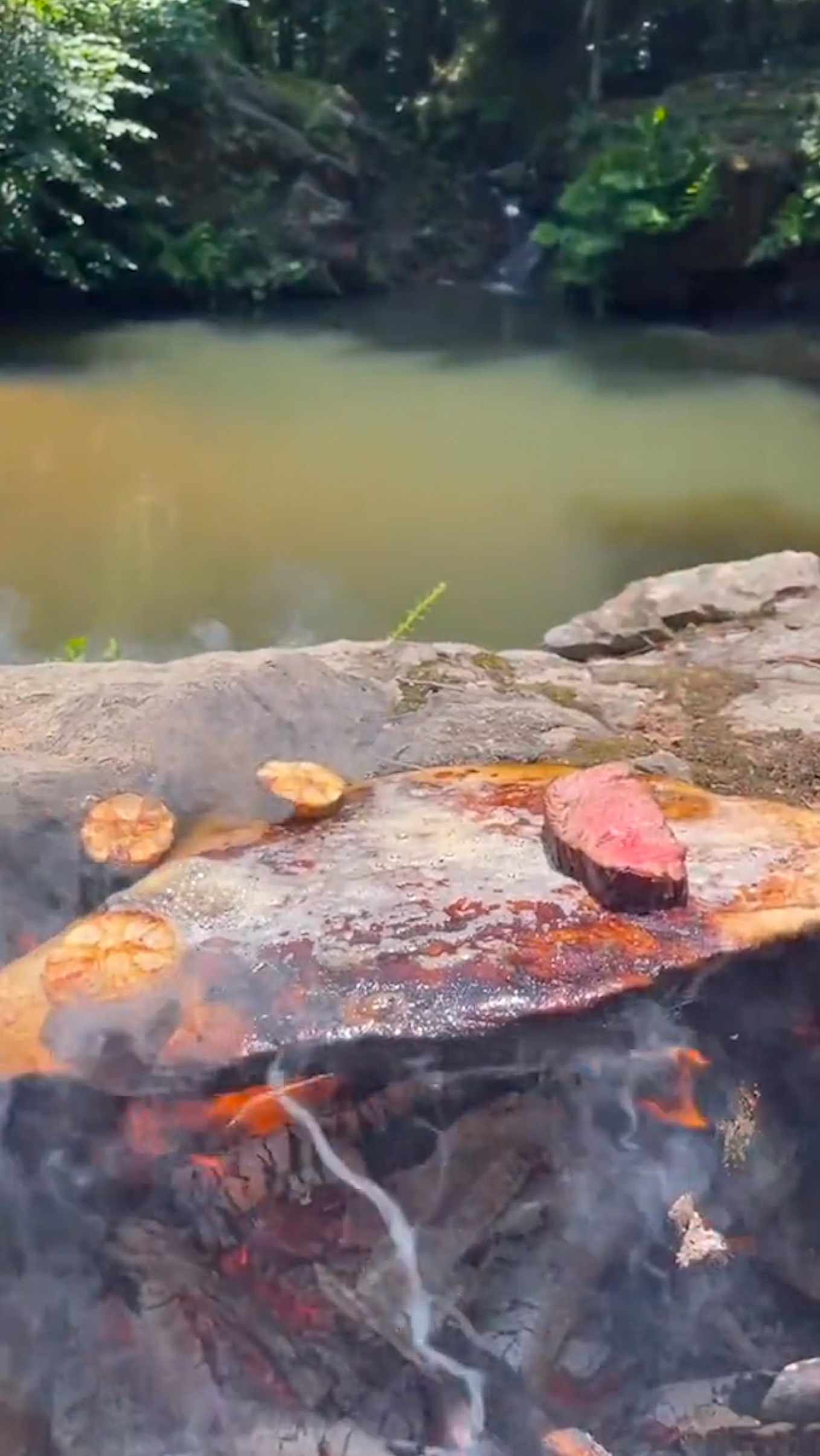 camping cooking on a stone