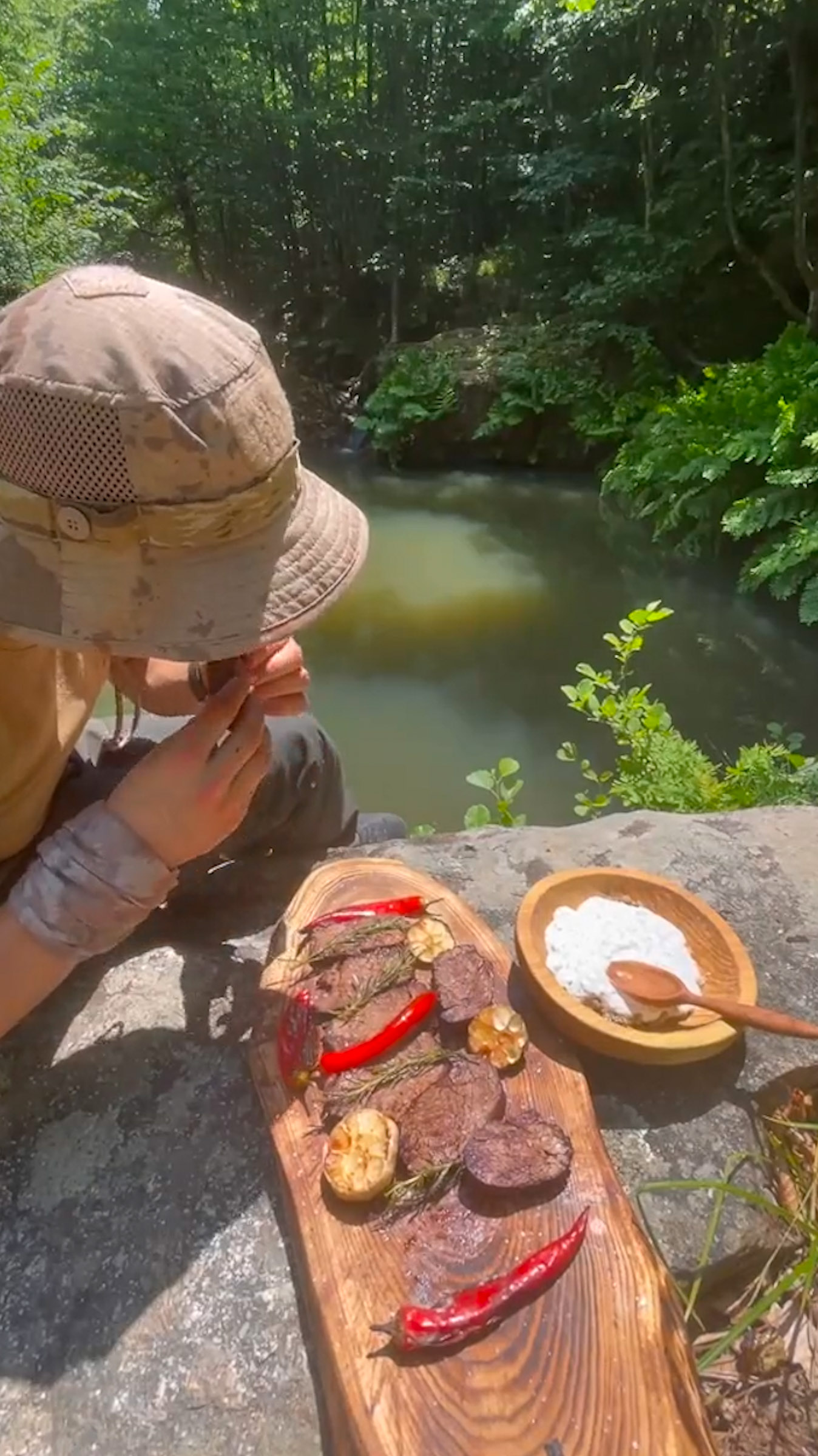 camping cooking on a stone