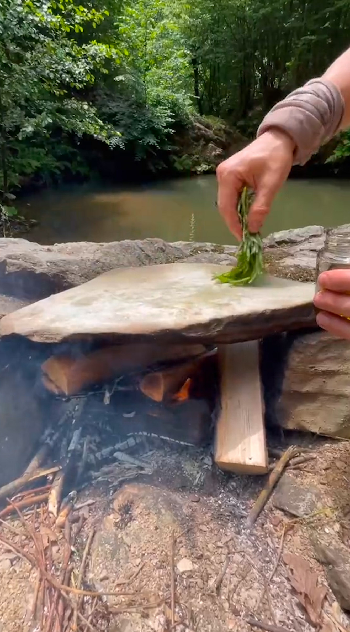 camping cooking on a stone